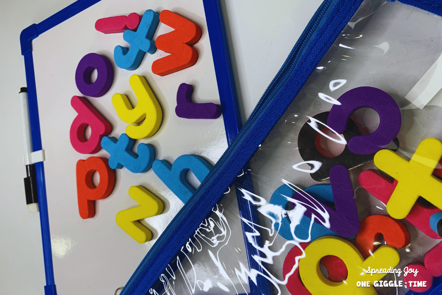 individual dry erase board and clear pouch containing colorful magnetic letters.png