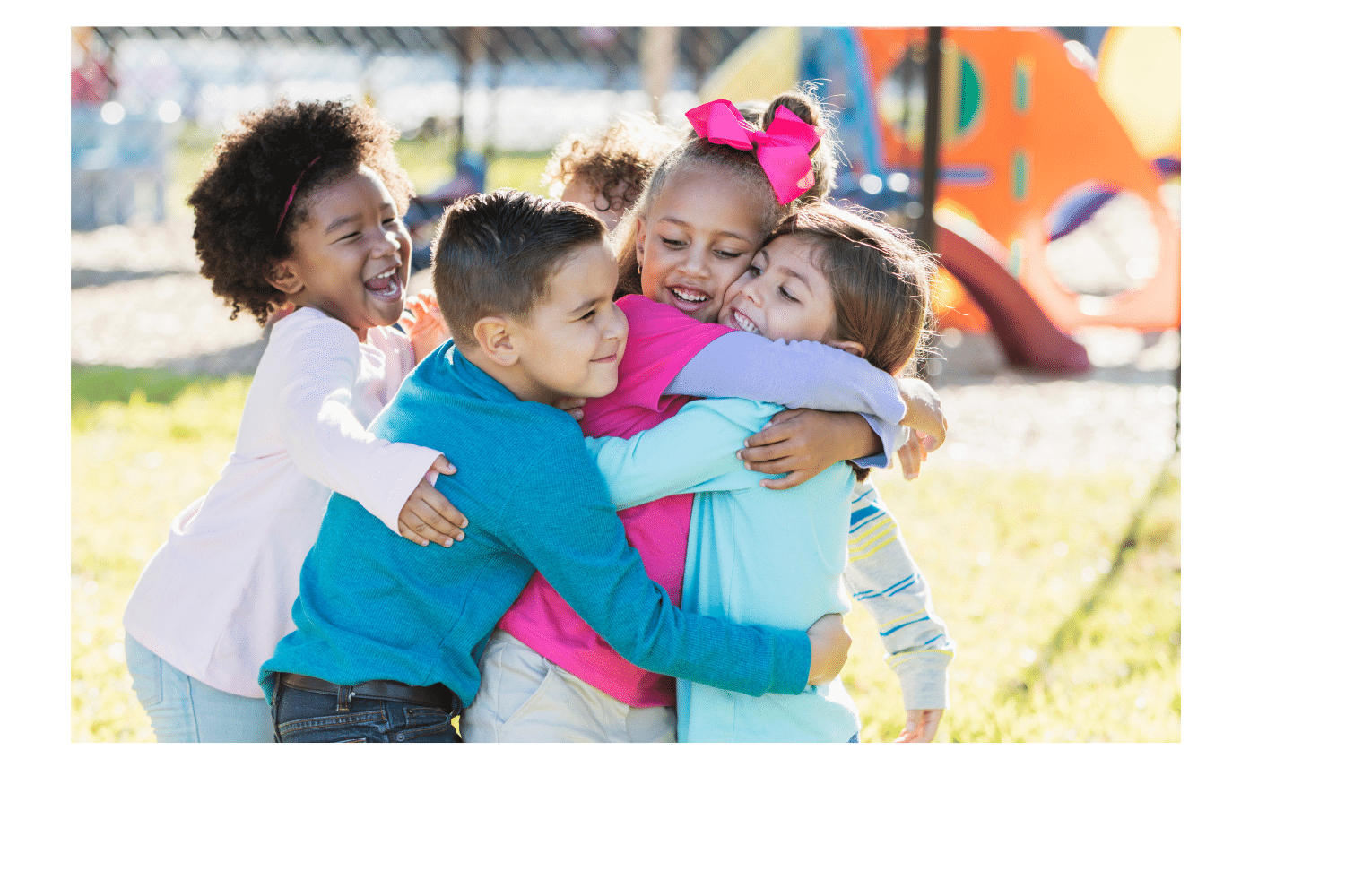 children hugging each other on the playground